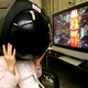 Toshiba Corp. employee Aira Hotta wears a full-faced prototype headgear to see a 360-degree Tokyo night view in 2006 (AP Photo/Shuji Kajiyama)